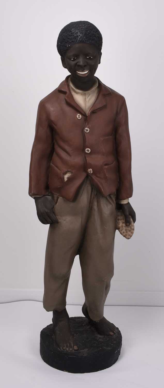 Lot 24 - Life size polychrome plaster figure of a young black boy