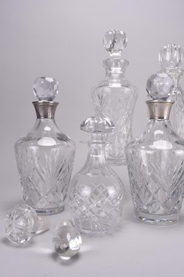 Lot 33 - Eight cut and plain glass decanters, including four with silver collars