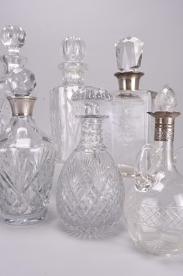 Lot 33 - Eight cut and plain glass decanters, including four with silver collars