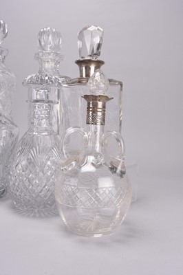 Lot 33 - Eight cut and plain glass decanters, including four with silver collars