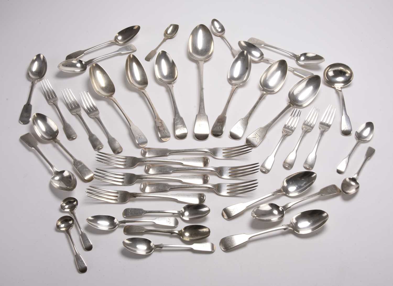 Lot 132 - A matched set of George III silver Fiddle pattern flatware
