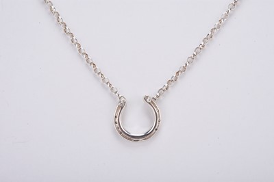 Lot 140 - A Rosemary Hetherington diamond set silver horseshoe pendant on chain