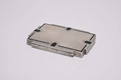 Lot 52 - An Art Deco white metal and black enamel cigarette case