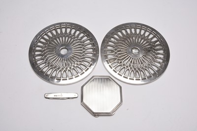 Lot 24 - An Art Deco silver compact, two silver mounted coasters and a knife