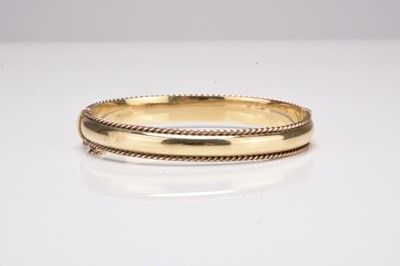 Lot 332 - A 9ct gold hinged bangle