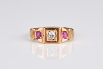 Lot 299 - An 18ct gold three stone ruby and diamond ring