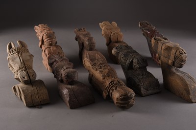 Lot 129 - A collection of nine carved wood wall mounts, India