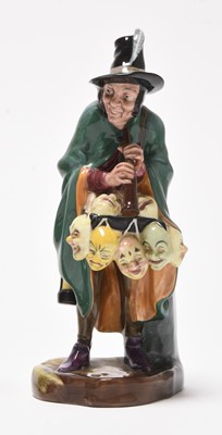Lot 162 - Three Royal Doulton figures including 'Mask Seller' HN2103 and a group of monk figures