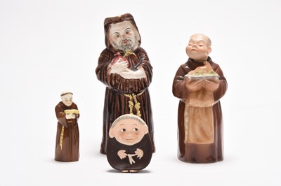 Lot 162 - Three Royal Doulton figures including 'Mask Seller' HN2103 and a group of monk figures