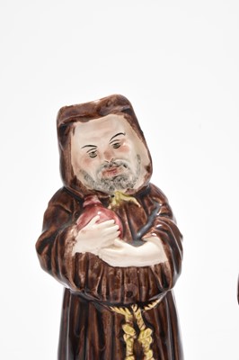 Lot 162 - Three Royal Doulton figures including 'Mask Seller' HN2103 and a group of monk figures