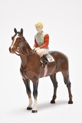 Lot 178 - Three horses including a Beswick jockey and two Poole dishes