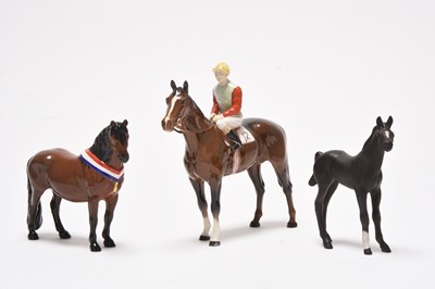 Lot 178 - Three horses including a Beswick jockey and two Poole dishes