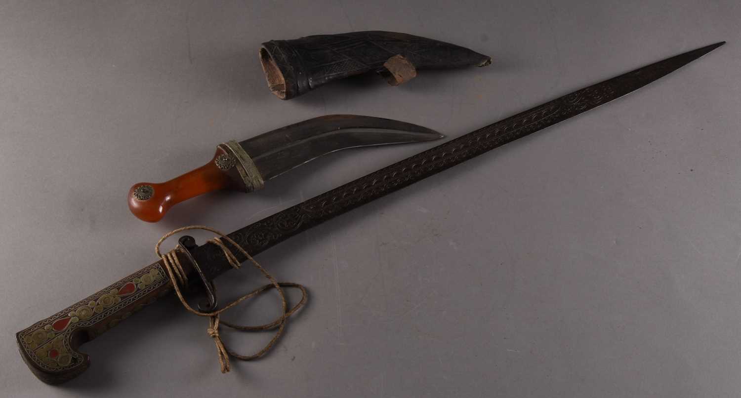 Lot 224 - An Algerian decorative sword and a near Eastern Jambiya dagger
