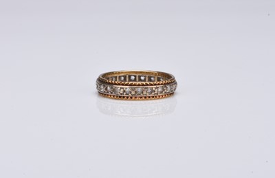 Lot 246 - A yellow and white metal paste set band