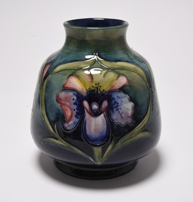 Lot 182 - An unusual Walter Moorcroft vase decorated with three different flowers