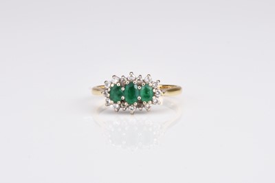 Lot 268 - An 18ct gold emerald and diamond cluster ring