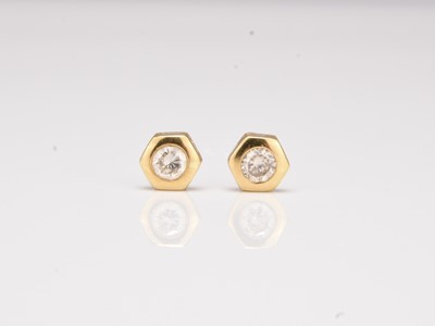 Lot A pair of 18ct gold diamond stud earrings