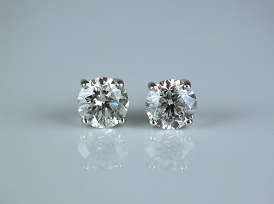 Lot 143 - A pair of 18ct white gold brilliant cut diamond earrings