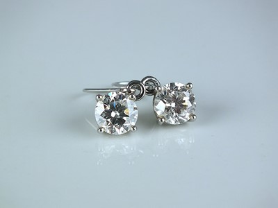 Lot 202 - A pair of brilliant cut diamond earrings