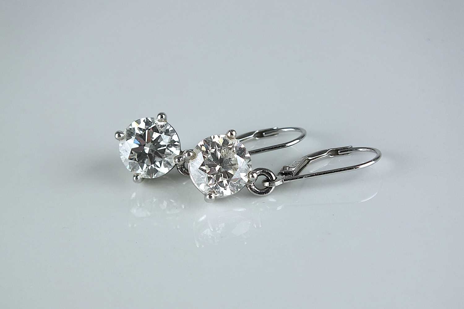 Lot 202 - A pair of brilliant cut diamond earrings