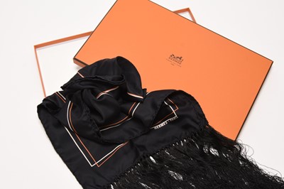 Lot 314 - A Hermes silk evening scarf, black with orange and white trim