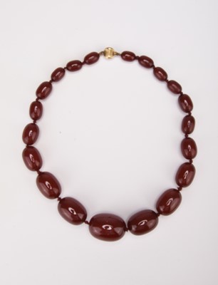 Lot 319 - A graduated ‘cherry red’ amber style bead necklace