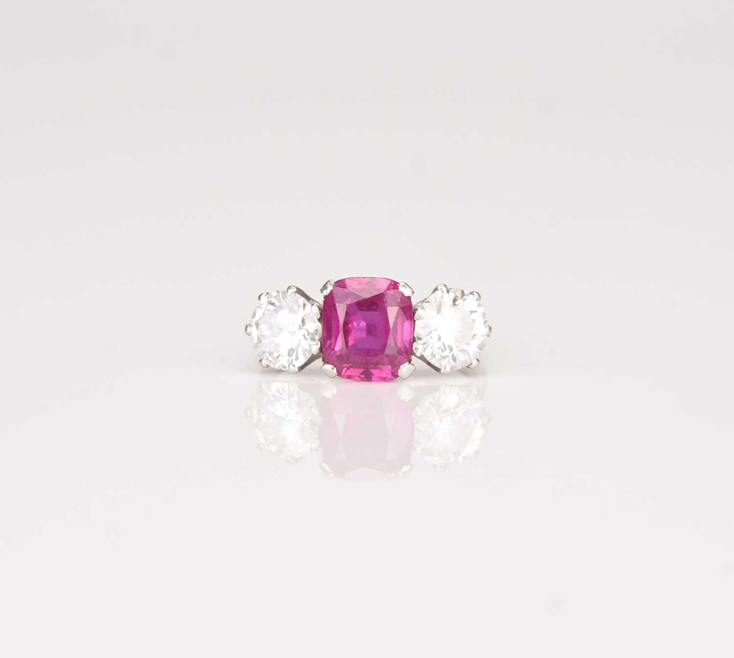 Lot 161 - A three stone ruby and diamond ring