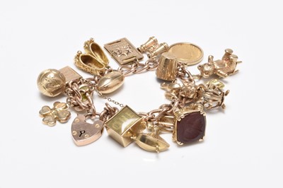 Lot A 9ct gold bracelet with attached 9ct gold and yellow metal charms