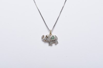 Lot 157 - A diamond, emerald and sapphire set elephant pendant