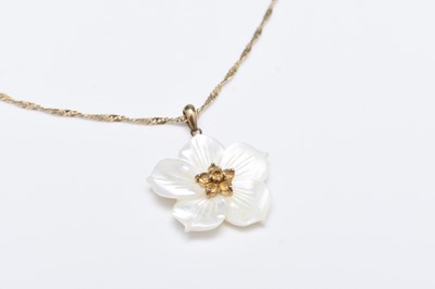 Lot 195 - A mother of pearl and citrine flower pendant on chain