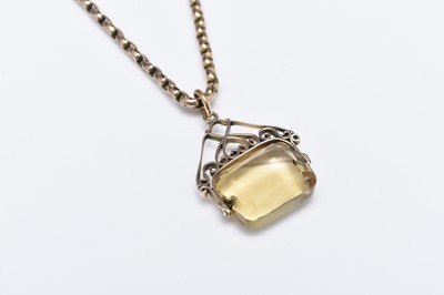 Lot 275 - A yellow metal chain suspending a citrine swivel fob