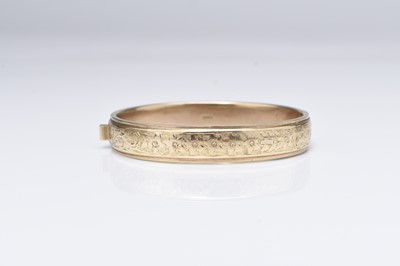 Lot 183 - A 9ct gold hinged bangle