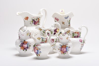 Lot 46 - A matched set of seven English relief-moulded floral jugs, circa 1820-30