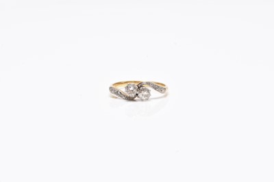 Lot 101 - A two stone diamond crossover ring