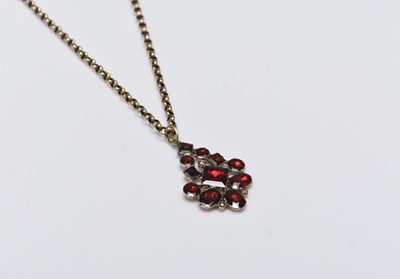 Lot 180 - A 19th century garnet and split pearl set pendant on chain