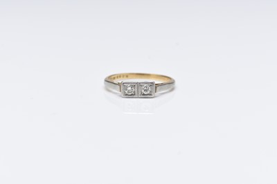 Lot 302 - A two stone diamond ring