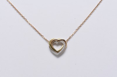 Lot 197 - A Cartier 18ct tri-coloured gold diamond set heart pendant on chain