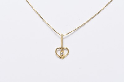 Lot 303 - A Tiffany 18ct gold chain suspending diamond set heart shaped pendant