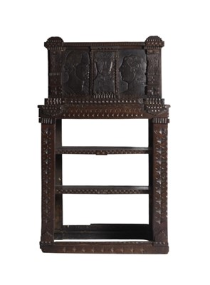 Lot 101 - A 17th century and later rustic carved oak open bookcase chiffonier