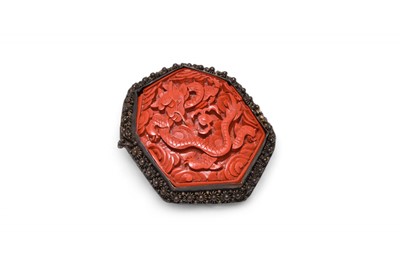 Lot 57 - A Chinese cinnabar lacquer and white metal brooch