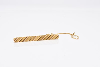 Lot 81 - A yellow metal tie slide