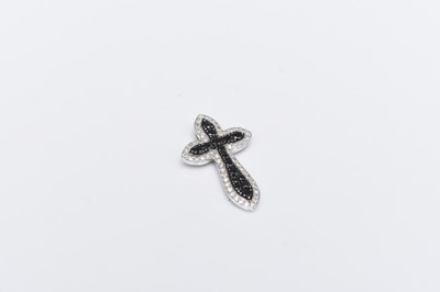 Lot 94 - A black and white diamond cross pendant