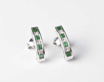 Lot 250 - A pair of 18ct white gold emerald and diamond earrings