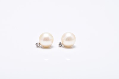 Lot 136 - A pair of diamond and cultured pearl stud earrings