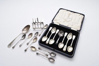 Lot 58 - A collection of silver spoons and a silver toast rack