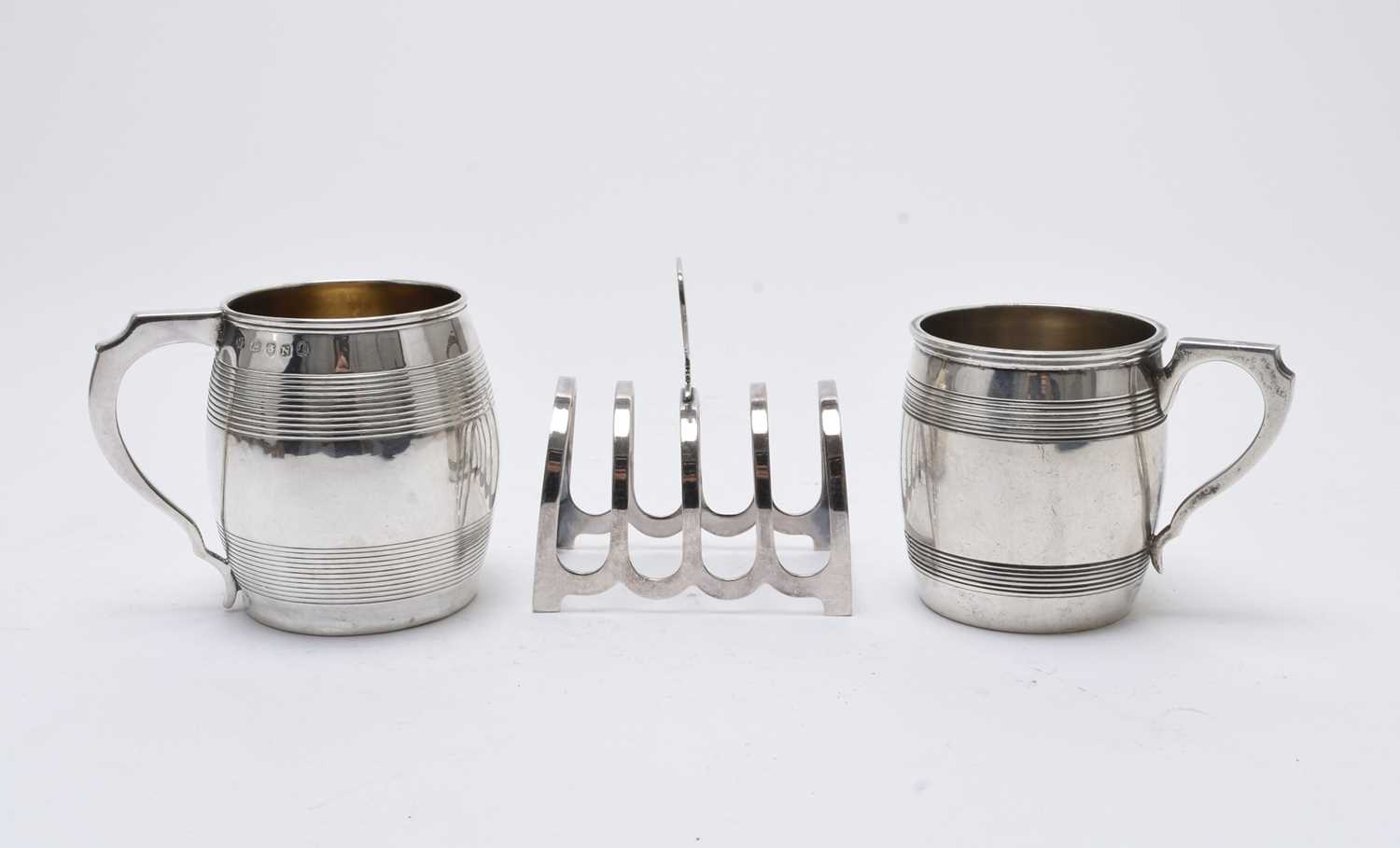 Lot 53 - Two silver mugs and a silver toast rack