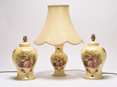 Lot 107 - Three Aynsley Orchard Gold table lamps decorated with fruit