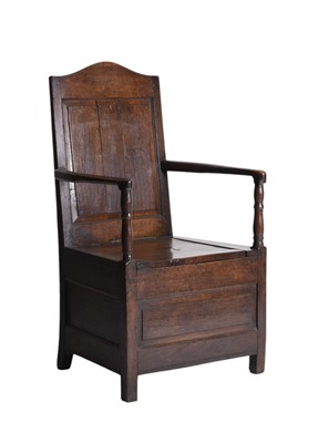 Lot 98 - An early 18th century oak box or commode armchair