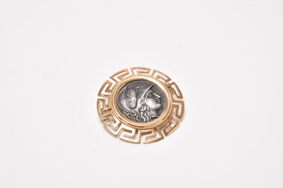 Lot 119 - A yellow metal mounted reproduction coin brooch