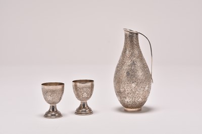 Lot 208 - A cased white metal ewer and two cups
